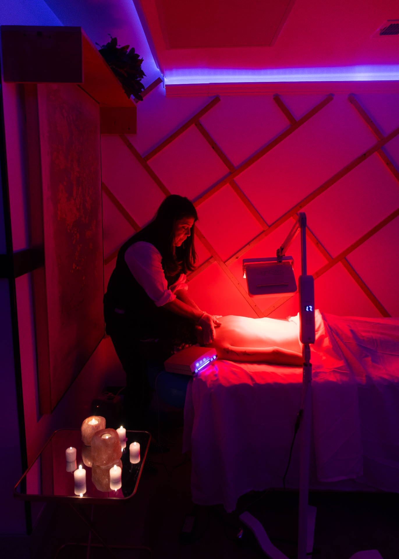 Red light therapy massage session in the salt-lamp lit treatment room at HBL Spa